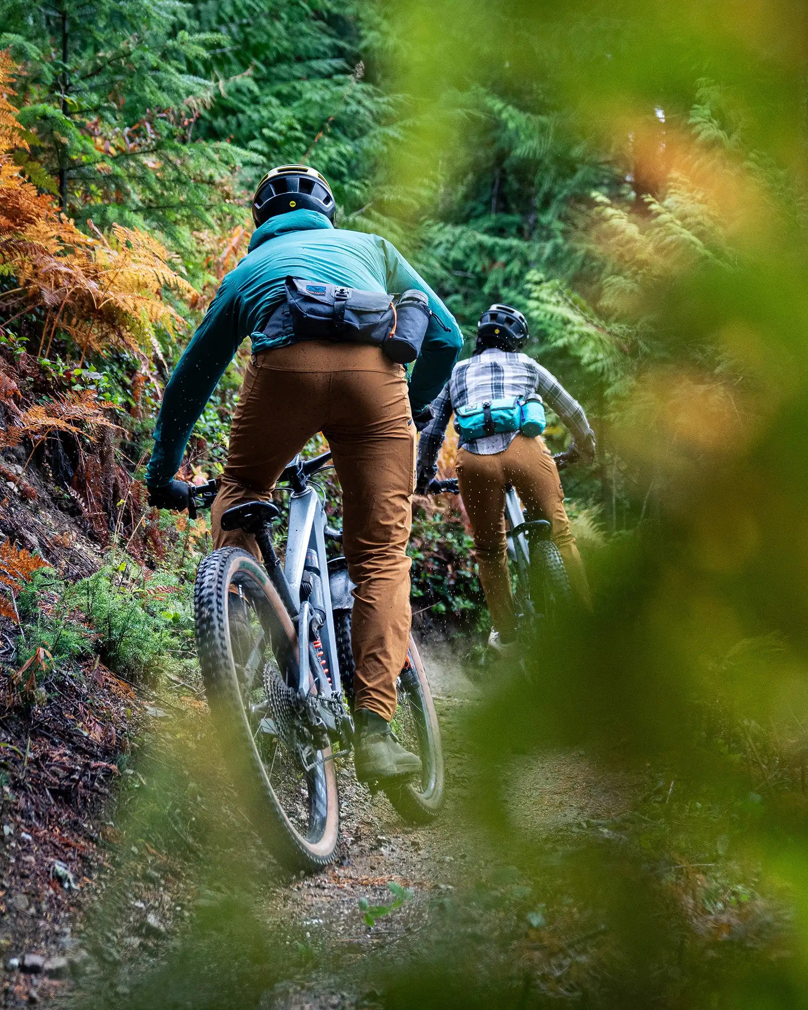 Two mountain bike riders wearing high above venture hip packs