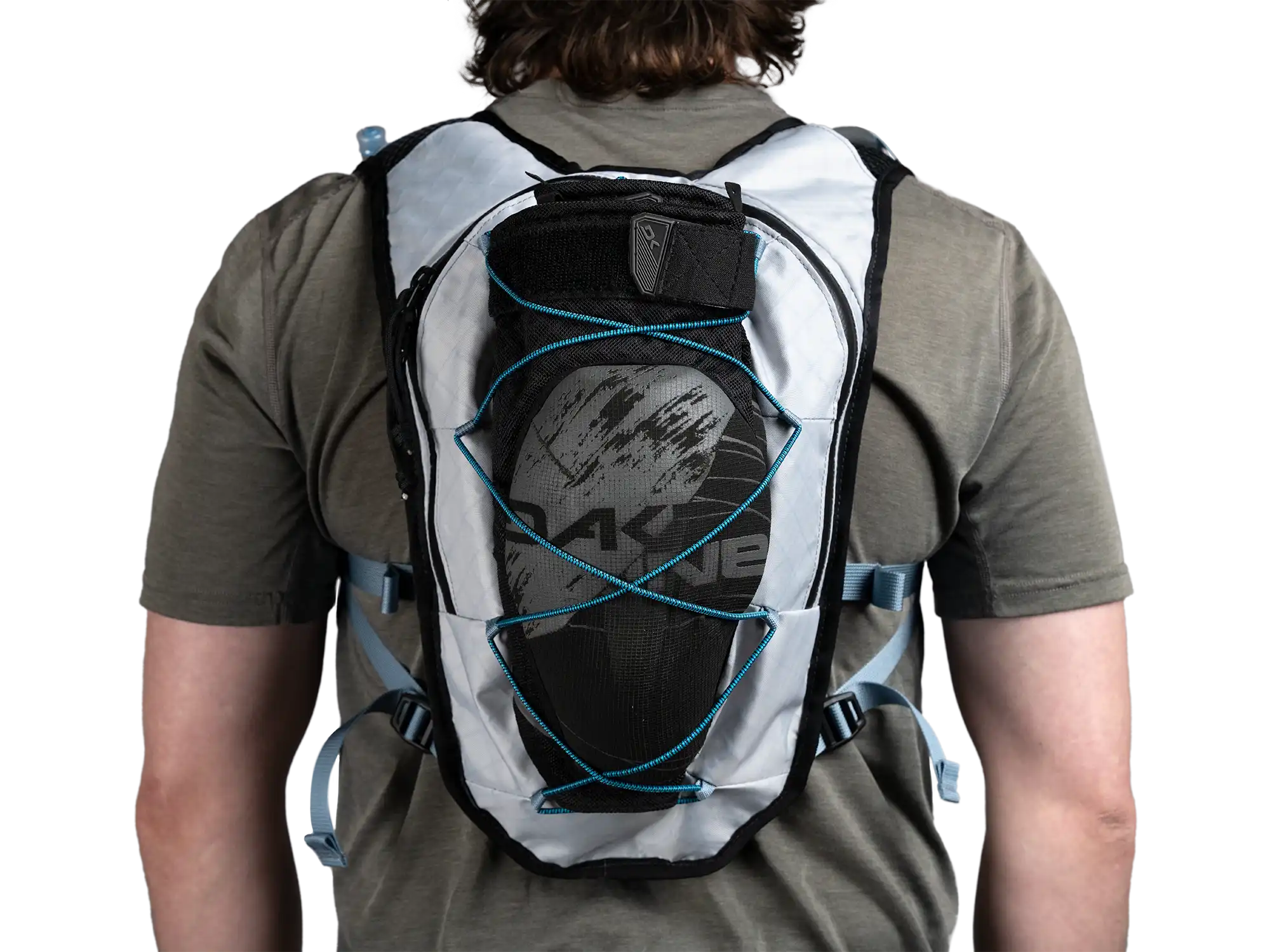 Back view of person wearing High Above Supernatural Hydration Vest Pack with knee pads stored in bungee system