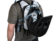 Back view of person wearing High Above Supernatural Hydration Vest Pack showing full face helmet carry system.