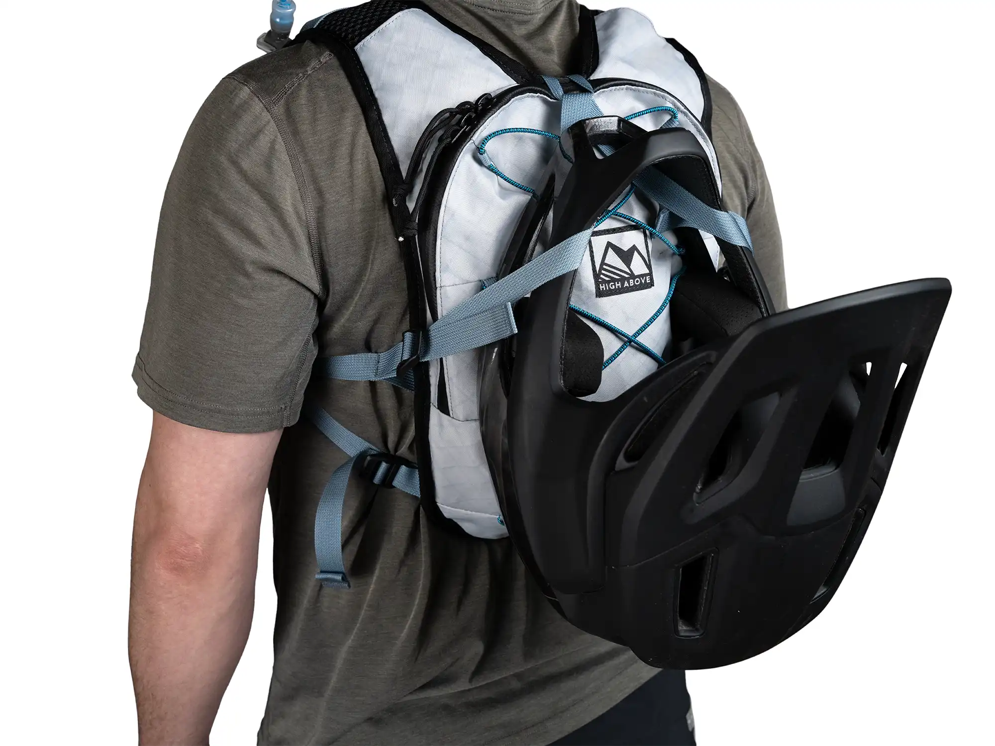 Back view of person wearing High Above Supernatural Hydration Vest Pack showing full face helmet carry system.