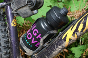 High Above 22 oz Water Bottle in bottle cage on mountain bike.