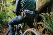 Mountain bike rider wearing High Above Lookout Hip Pack