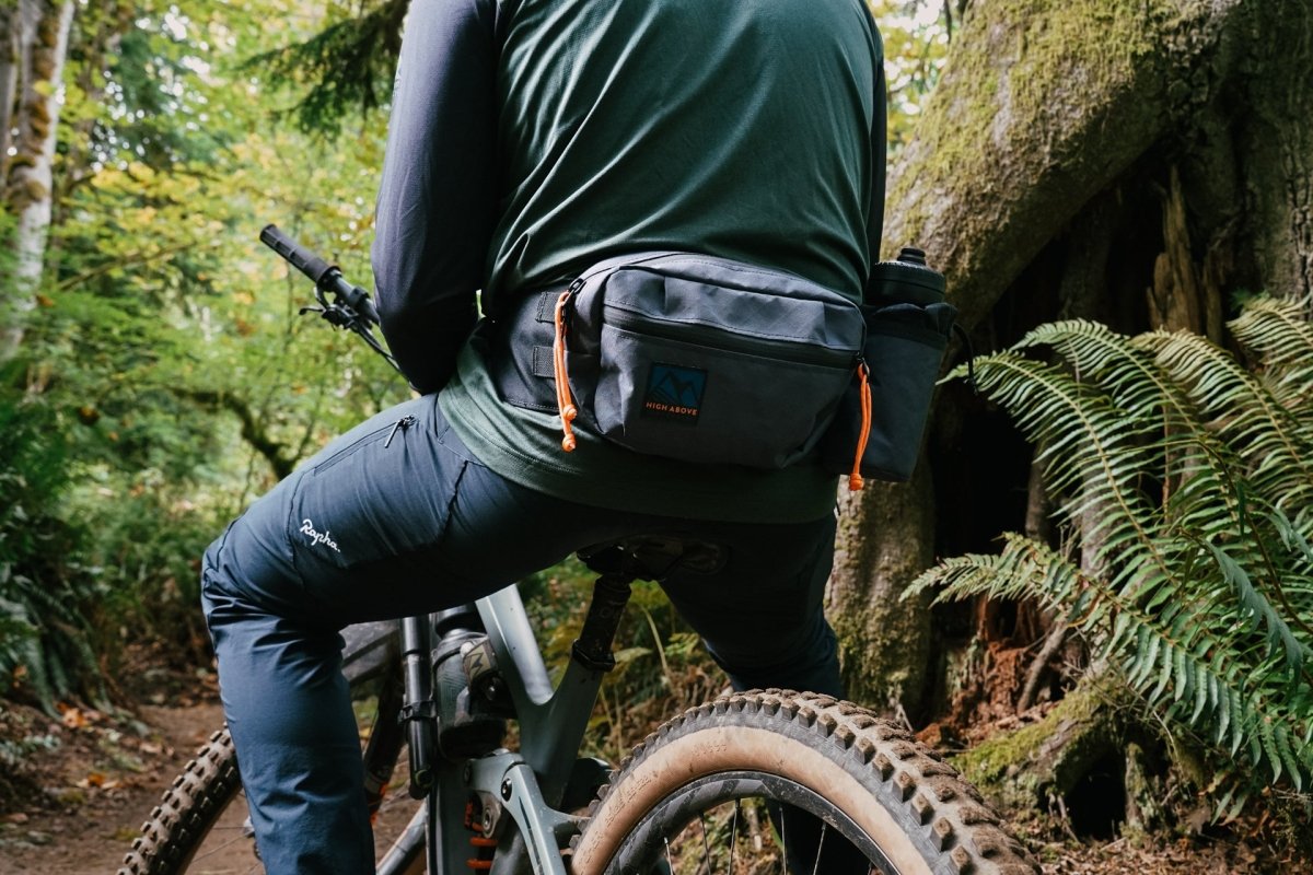 Mountain bike rider wearing High Above Lookout Hip Pack
