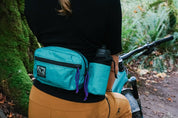 Female mountain bike rider wearing High Above Lookout Hip Pack