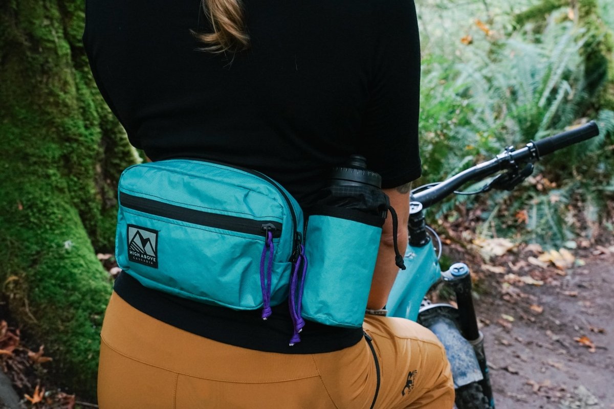 Female mountain bike rider wearing High Above Lookout Hip Pack