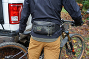 Mountain biker wearing High Above Rad Pack Hip Pack in Camo