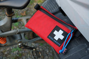 High Above Trail First Aid Kit with mountain bike in background.
