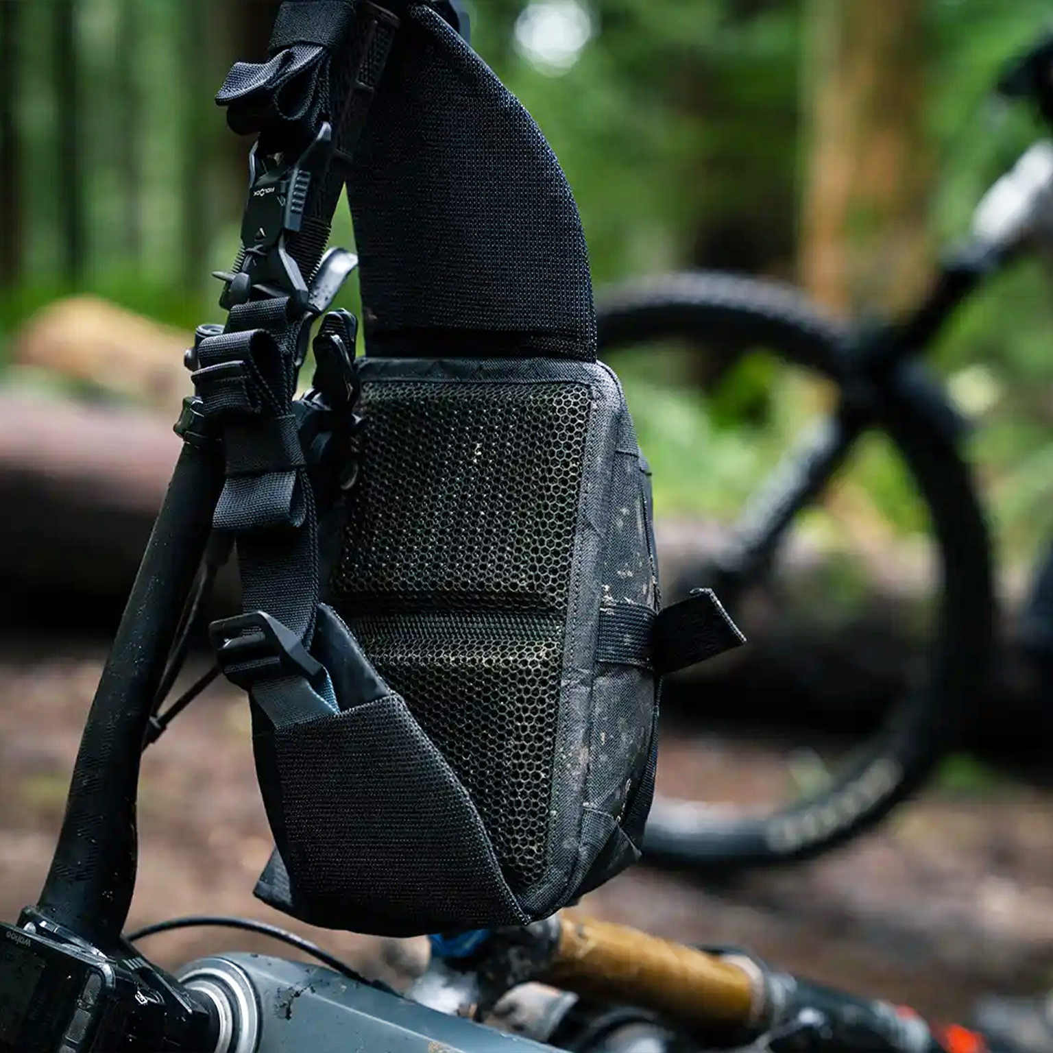 High Above Venture 3D Hip Pack Hanging from handlebars of mountain bike in the forest.
